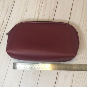 Burgundy travel makeup bag with brush insert